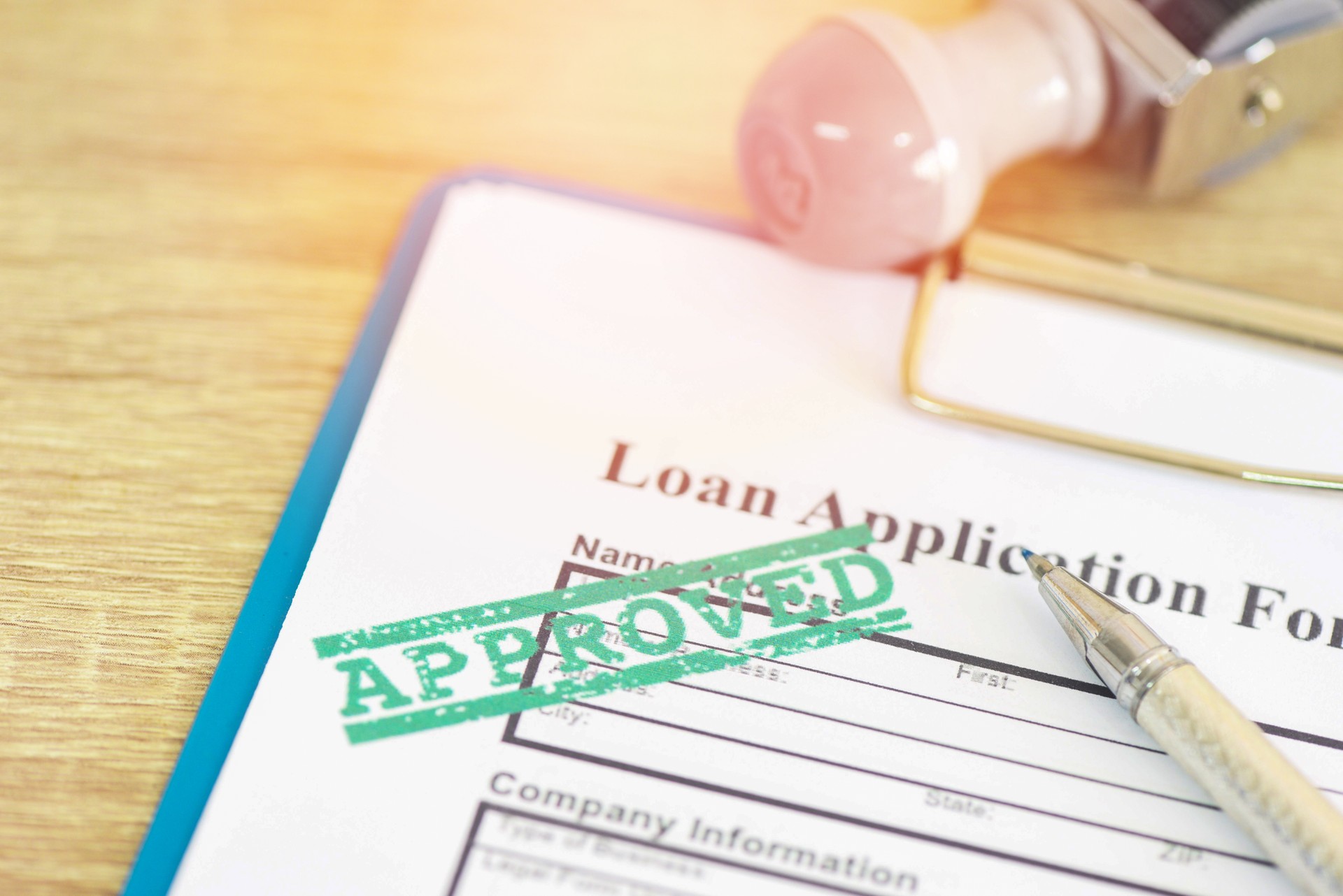 Loan approval, Loan application form with Rubber stamping that says Loan Approved, Financial loan money contract agreement company credit or person.